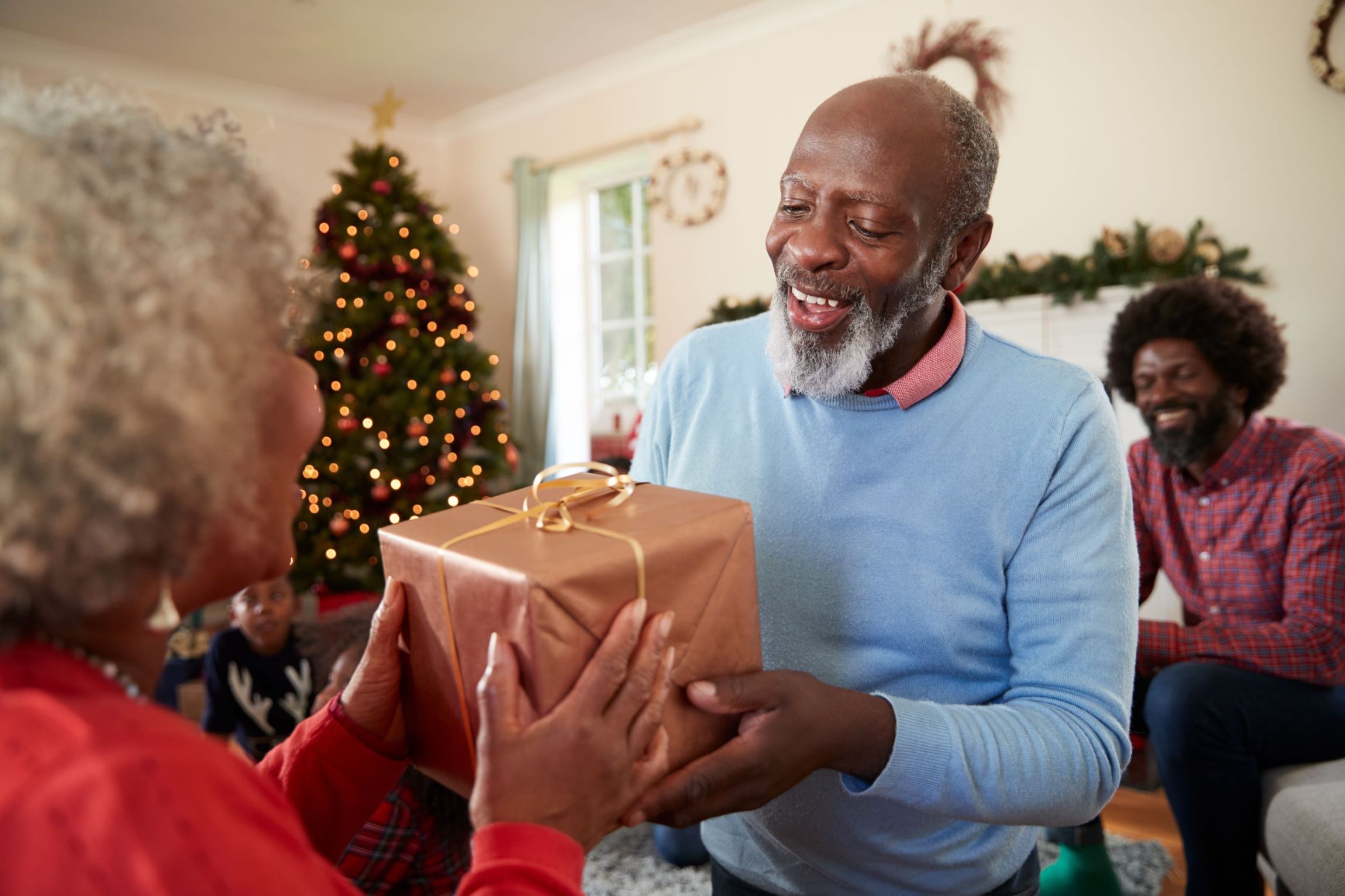 family giving gifts at christmas resized 2